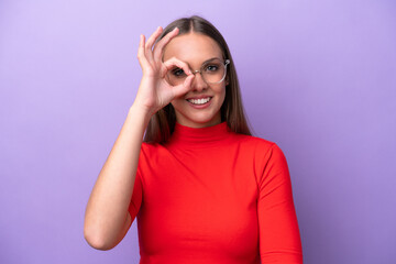 Young caucasian woman isolated on purple background With glasses with happy expression