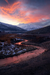 Burning snowy mountain sunset with stream over Mt Timpanogos in Heber Valley, Utah