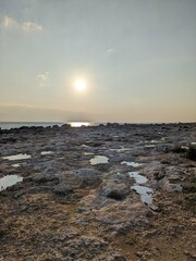 Sun reflected in puddles and rocks