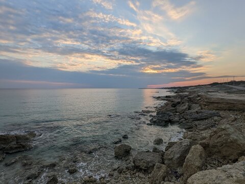 Sunset on the sea with rocks and clouds