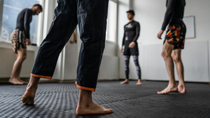 Fototapeta na wymiar Close up on leg of unknown man at brazilian jiu jitsu bjj training copy space martial arts concept