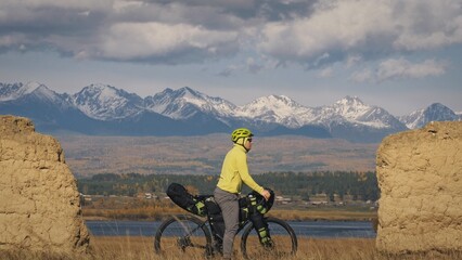 The man travel on mixed terrain cycle touring with bikepacking. The traveler journey with bicycle...