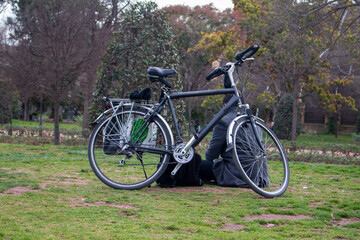 Fototapeta na wymiar bicycle man alone in the park bicycle man rest in the park Portrait of man with bicycle relaxing in park near the bike calm moment in ciutadella park in Barcelona, spain