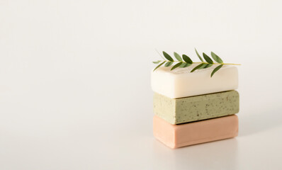 Natural handmade soap or dry shampoo organic spa bars on light white background. Homemade beauty products with natural essential oils and plants extracts. Copy empty space.