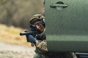 Nasty feminine soldier focusing on target hiding. High quality photo