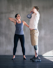 Devoted to my patients health. Shot of a female physiotherapist having a session with a young male...