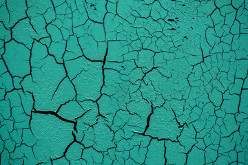 Cracked and damaged painted surface of a building or wall. Texture, aged paint background