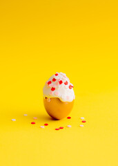 Cake egg with decorative flowers. Easter background. Minimal concept.