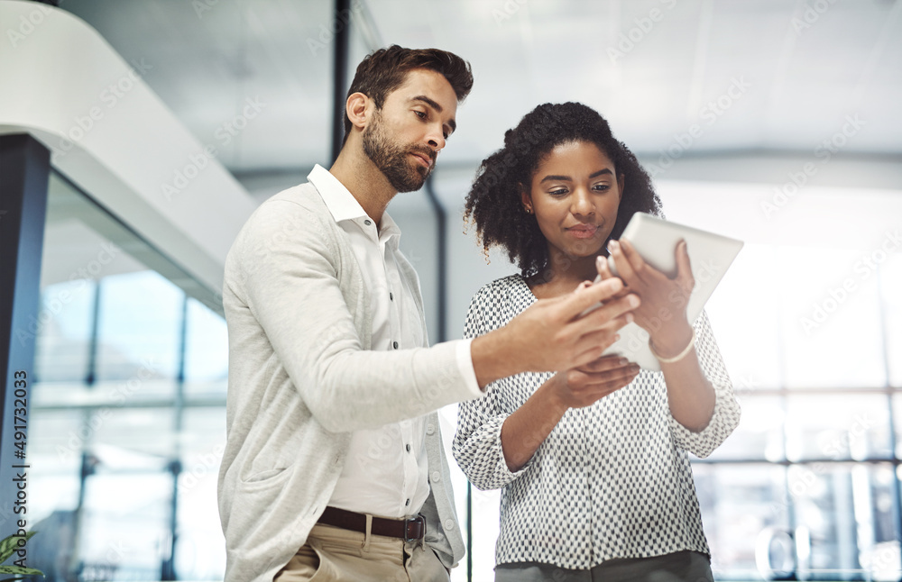 Canvas Prints offering his guidance and support. shot of two businesspeople discussing something on a digital tabl