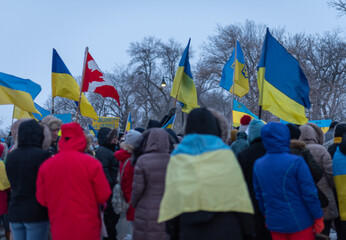 group of people on the street with Ukrainian flags at the anti-war demonstration in Regina, Saskatchewan, Canada.