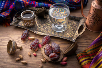 coffee, dates and a glass of water on the table