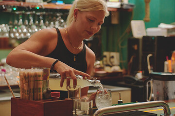 Female barman preparing drinks. cocktail bar Drinks at the bar. Fresh and cold drinks in a bar. Watermelon drink, jamiaca drink, margarita, micheladas.