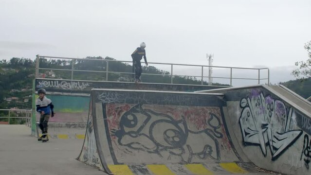 young males jump at skatepark