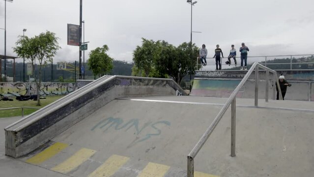 male jumps at skatepark, in slowmotion
