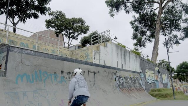 Male does tricks at skatepark, in slow motion