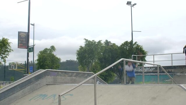 three people jump at skatepark