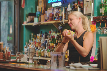 Female barman preparing drinks. cocktail bar Drinks at the bar. Fresh and cold drinks in a bar. Watermelon drink, jamiaca drink, margarita, micheladas.