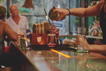 Female barman preparing drinks. cocktail bar Drinks at the bar. Fresh and cold drinks in a bar. Watermelon drink, jamiaca drink, margarita, micheladas.