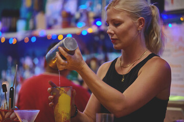 Female barman preparing drinks. cocktail bar Drinks at the bar. Fresh and cold drinks in a bar....
