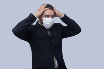 isolated businessman using mask to protect himself from viruses