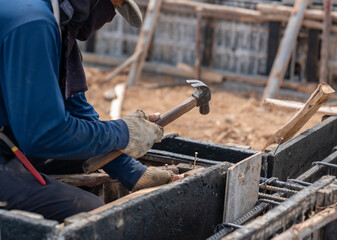 Worker use hammer hit support framework. © Zblaster