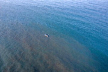 Aerial view of a fishing boat off Murud beach at Dapoli, located on the West Coast of Maharashtra India.