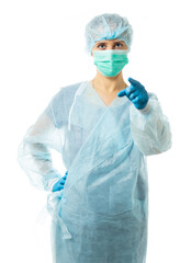 A nurse in sterile disposable clothes and a mask strictly looks at the camera and points a finger at us. isolated