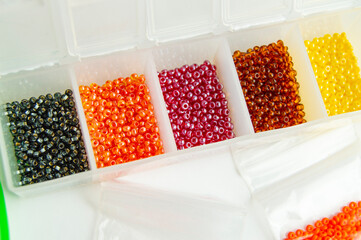 Fletley, plastic box with colorful beads for creativity and hobby, Bright sparkling beads on white background