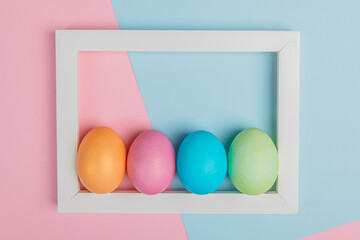 four eggs in a white frame on a pink-blue background