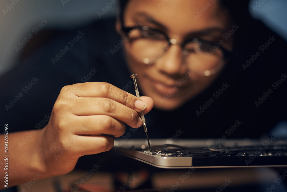 Poster the best computer repair technician in town. shot of a young technician using a screwdriver to repai