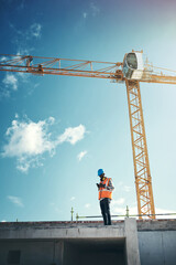 Updating project plans on the go. Shot of a young man using a smartphone while working at a...