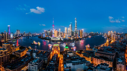Aerial view of city skyline and modern commercial buildings in Shanghai at night, China.
