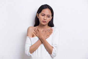 Young beautiful asian woman having heart attack isolated on white background
