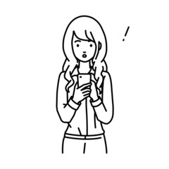 立ってスマートフォンを操作して何かに気づいて驚いたブラウスの女性