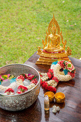 Flower garlands, water bowls, perfume and white clay filler for Buddha bathing ceremony on important religious days for Buddhists, New Year's and Songkran Festivals for Asians.