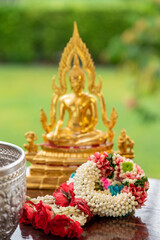 Flower garlands, water bowls, perfume and white clay filler for Buddha bathing ceremony on important religious days for Buddhists, New Year's and Songkran Festivals for Asians.