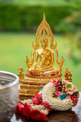 Fototapeta premium Flower garlands, water bowls, perfume and white clay filler for Buddha bathing ceremony on important religious days for Buddhists, New Year's and Songkran Festivals for Asians.