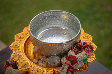 Flower garlands, water bowls, perfume and white clay filler for Buddha bathing ceremony on important religious days for Buddhists, New Year's and Songkran Festivals for Asians.