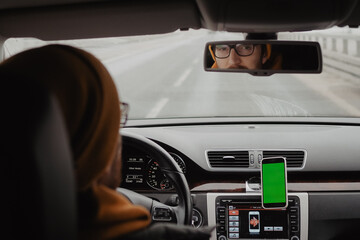 Millennial man drive the car and using mobile app , green screen