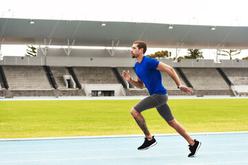 Hes quick. Full length shot of a handsome young male athlete running along the track.