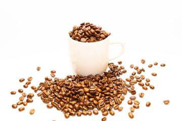coffee beans in a white cup, plus scattered beans, medium roasted, aromatic and with a white...