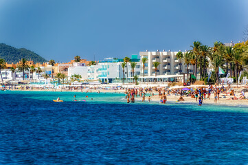 Scene from sandy beach at Ibiza during summer day.