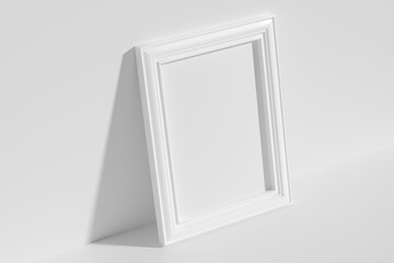 Rectangular photo frame on floor leaning at wall top diagonal view