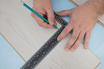 Floor renovation. Measuring before setting of the laminate floor