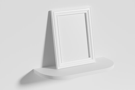 Rectangular photo frame on white rounded shelf leaning at wall top diagonal view