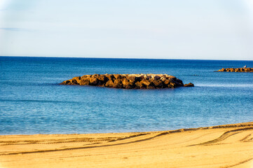 Fototapeta na wymiar Empty sandy beach during hot summer morning at Cambrils, Spain.