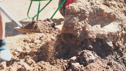 Person works outdoors. Worker digs ground. Honest labor concept.