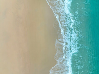 Top view of Soft waves with blue sea and sand  background on summer tropical in a holidays