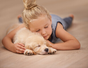 The best friend you can get. An adorable little girl with her puppy at home.