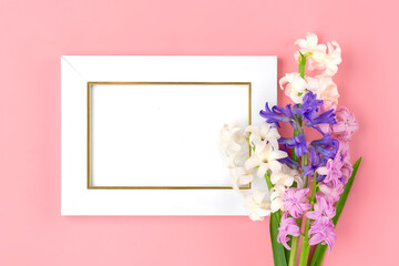 bouquet of spring flowers of lilac hyacinths on pink background Top view Flat lay Holiday card Hello spring concept